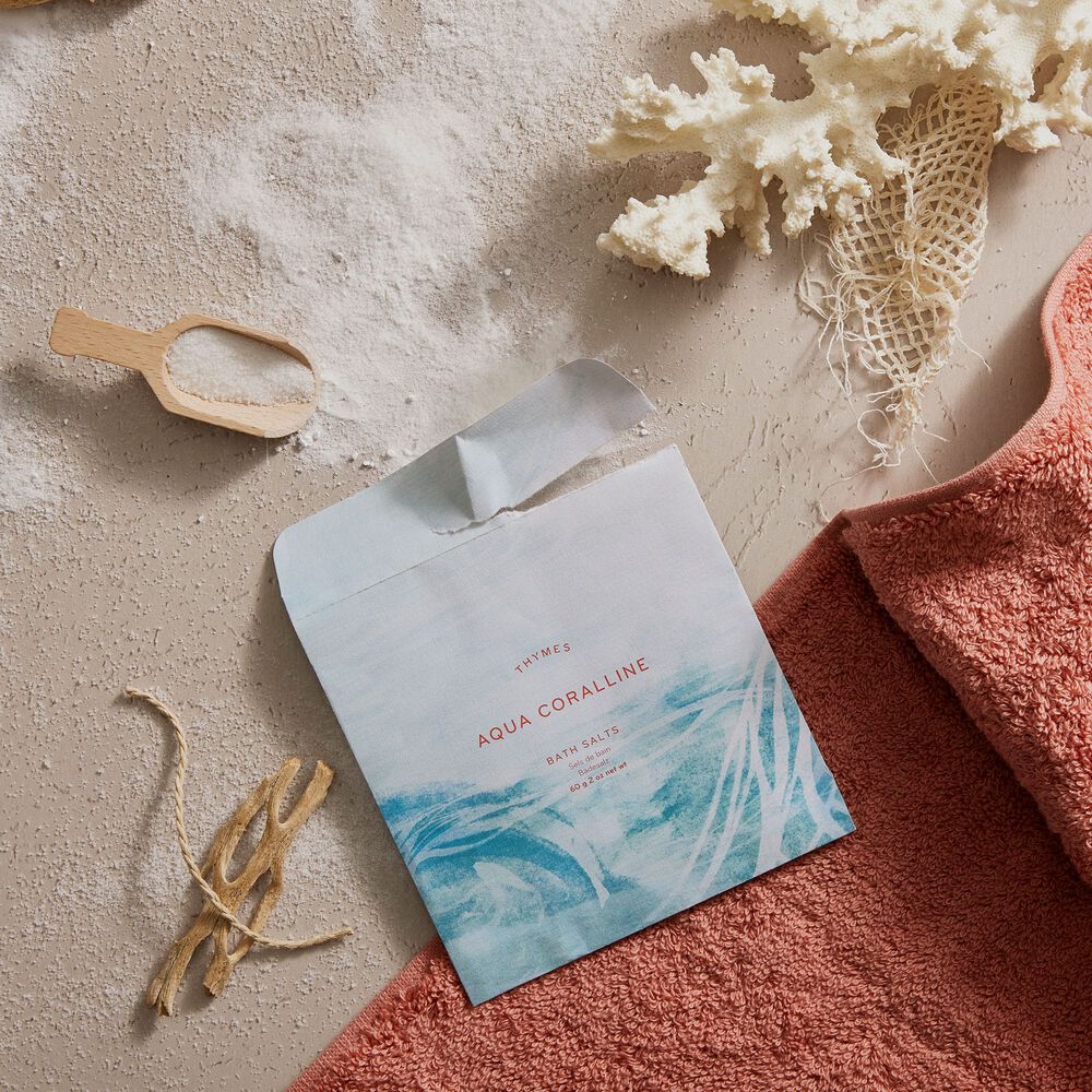 Thymes Neroli Sol Bath Salts Envelope for an Island Spa Experience flat lay with sand and shells image number 1